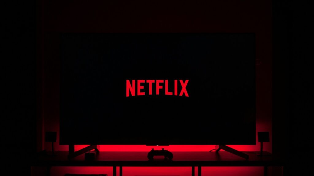Netflix logo against black background television console 